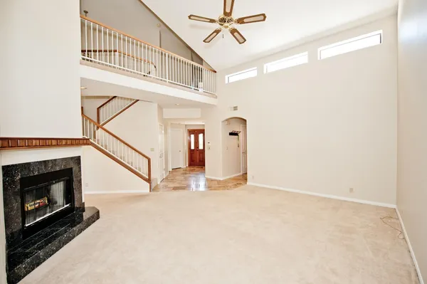 a view of a livingroom with wooden floor and a fireplace
