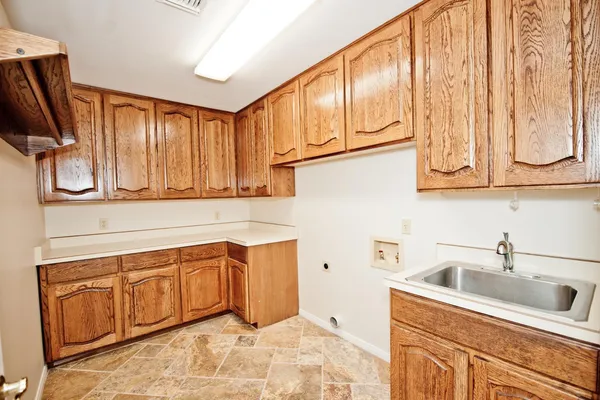 a kitchen with a sink cabinets and a window
