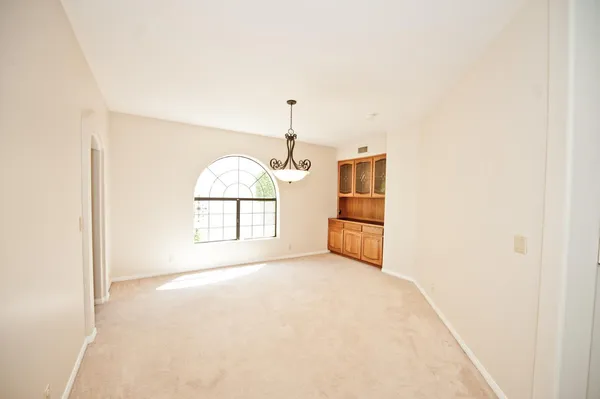 a view of a room with wooden floor and a window