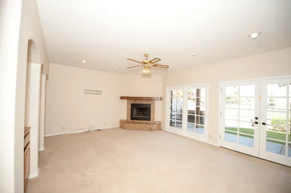 a view of an empty room with window and cabinet