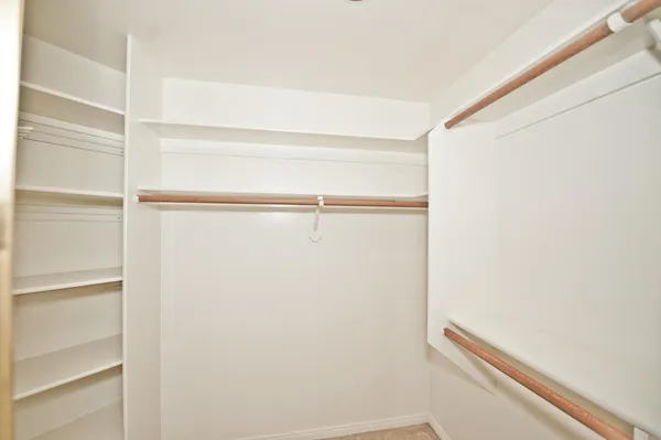 a spacious bathroom with a tub shower and a sink