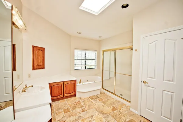 a bathroom with a bathtub and a window