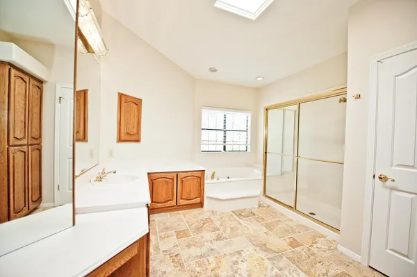 an empty room with a ceiling fan and a window