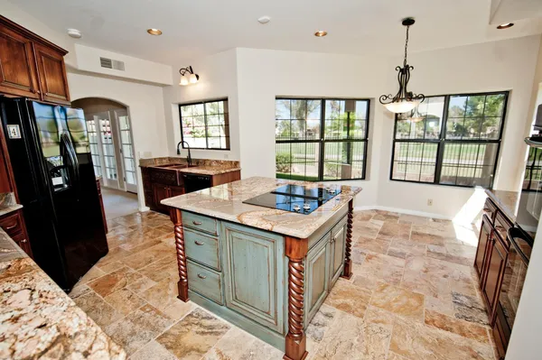 a view of a kitchen with granite countertop a sink a counter top space and stainless steel appliances