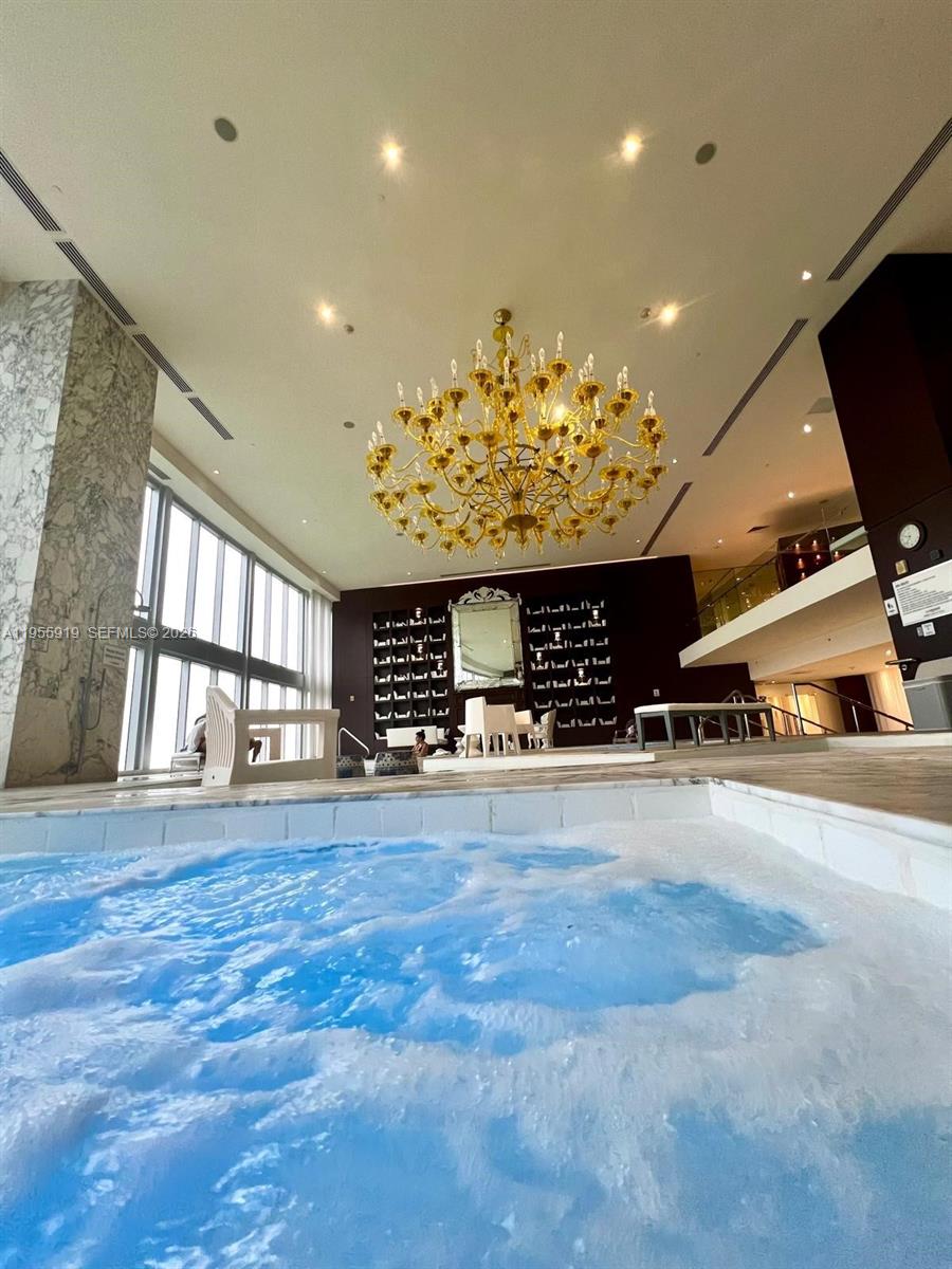 495 Brickell Avenue, Unit 3208 Miami, FL 33131 - Photo 32 of 51 a view of a hall with a flat screen tv