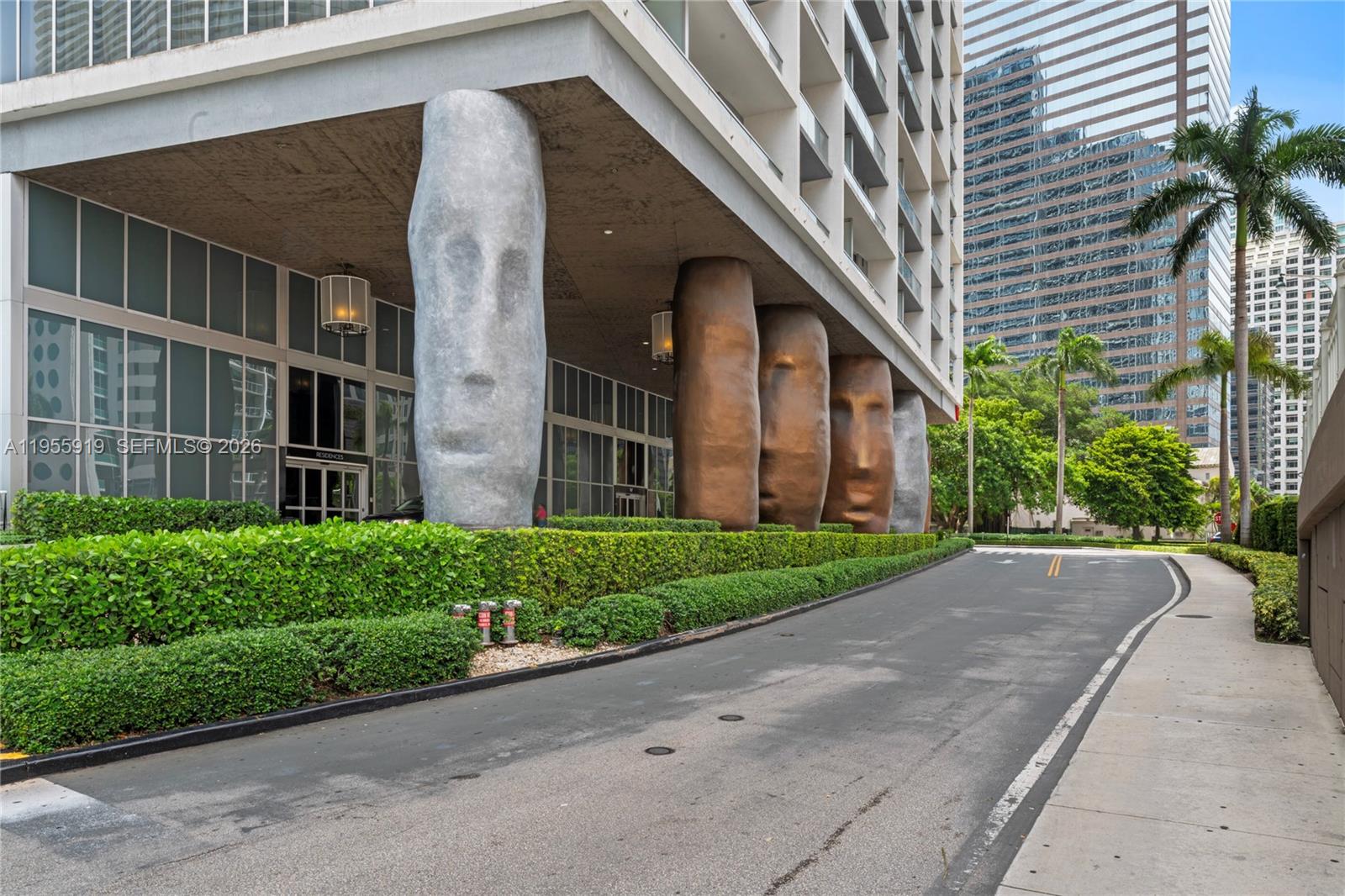 495 Brickell Avenue, Unit 3208 Miami, FL 33131 - Photo 46 of 51 a view of a brick house with a large windows plants and palm trees