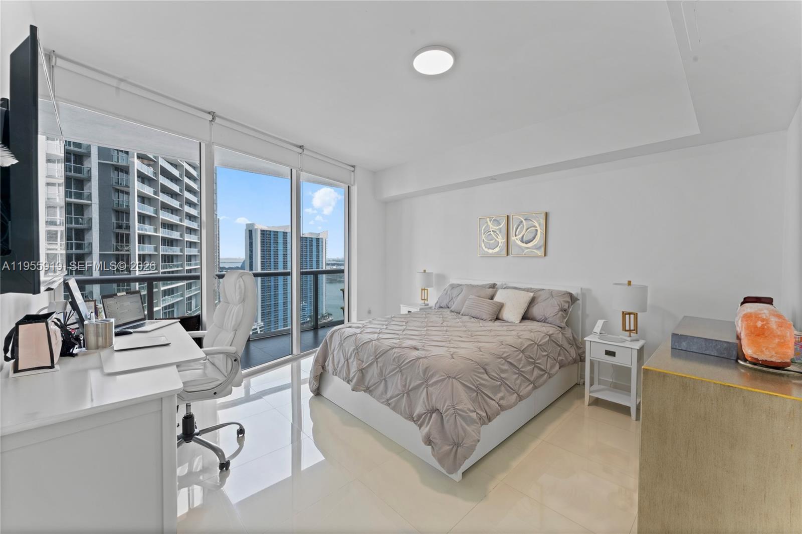 495 Brickell Avenue, Unit 3208 Miami, FL 33131 - Photo 9 of 51 a bedroom with a bed and glass door