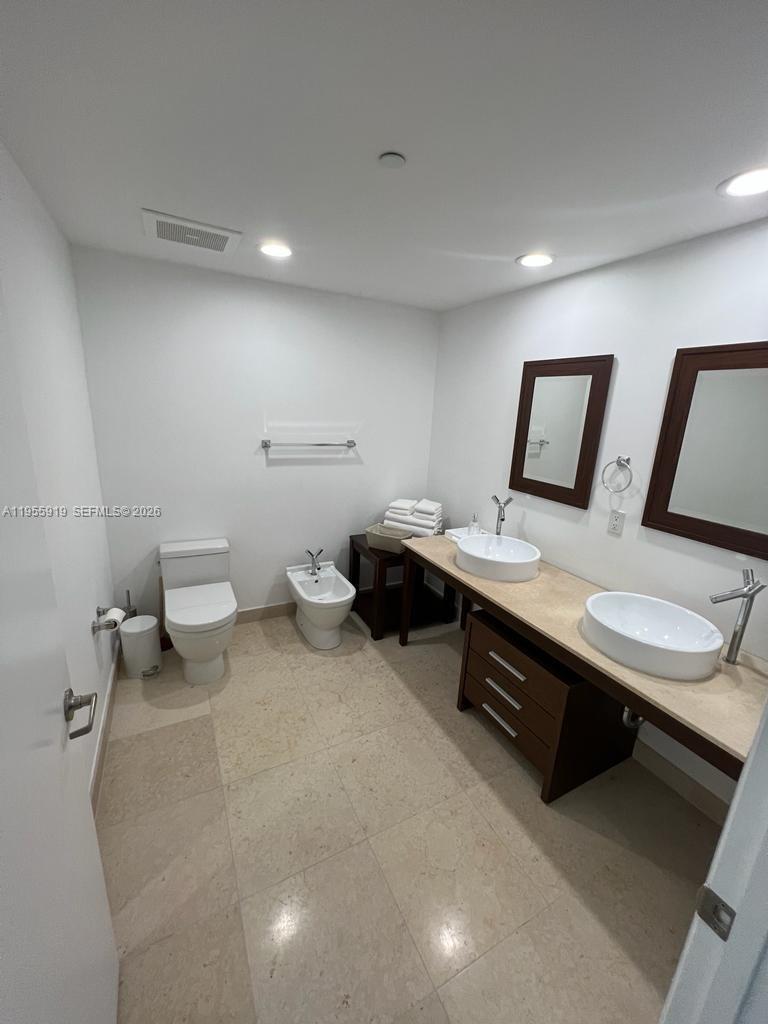 495 Brickell Avenue, Unit 3208 Miami, FL 33131 - Photo 10 of 51 a bathroom with a toilet sink and mirror