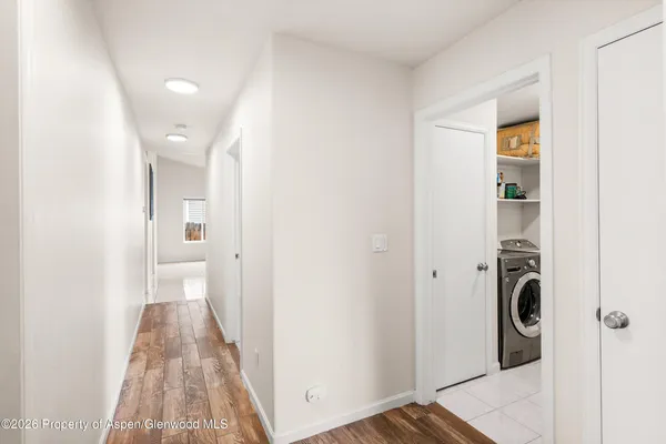 a view of a hallway with wooden floor