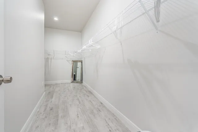 a view of a room with wooden floor