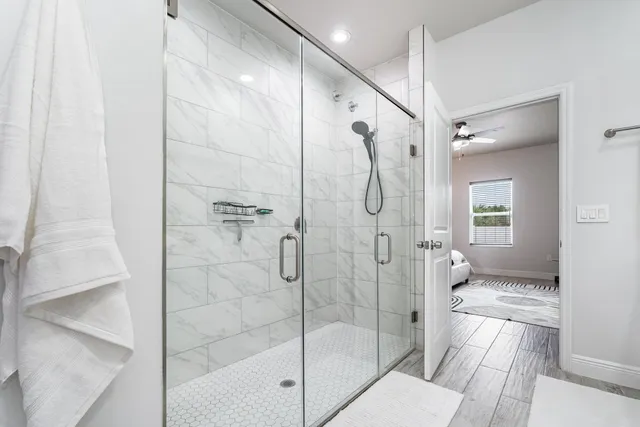 a bathroom with a glass shower door