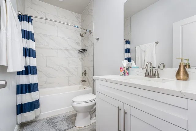 a bathroom with a sink a toilet a shower and a mirror