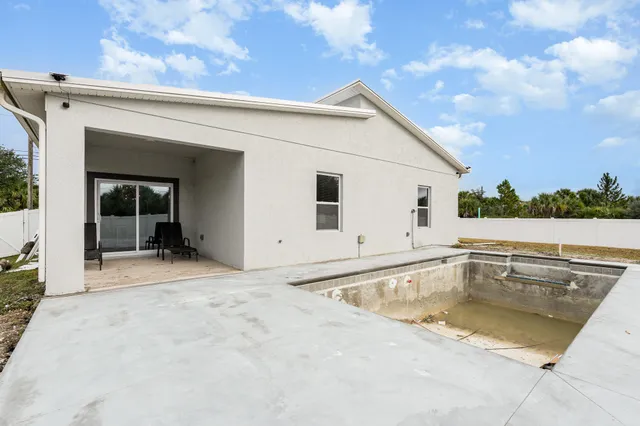 a view of white house with a yard