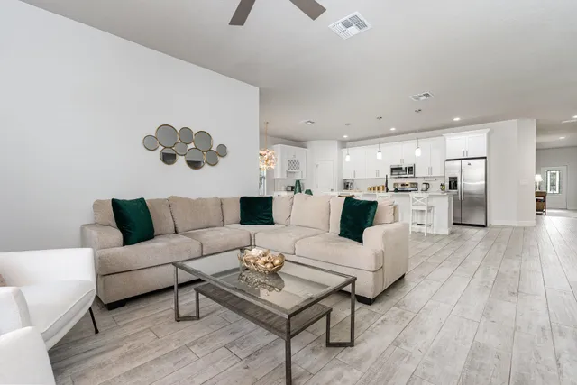 a living room with furniture and a wooden floor