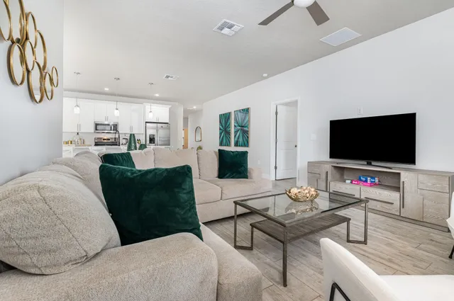 a living room with furniture and a flat screen tv