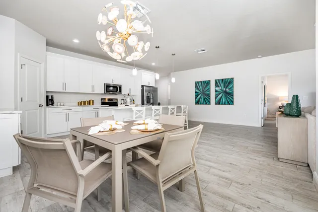 a view of a dining room with furniture and a kitchen