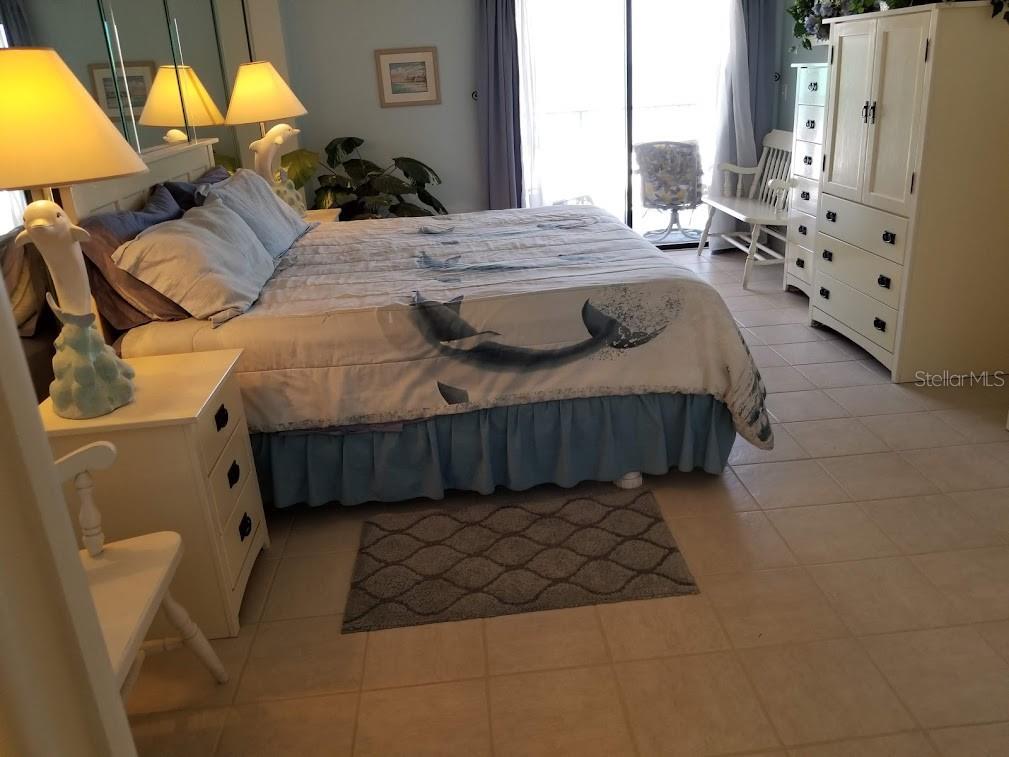13650 Gulf Boulevard, Unit 304 Madeira Beach, FL 33708 - Photo 39 of 63 a bedroom with a bed and window