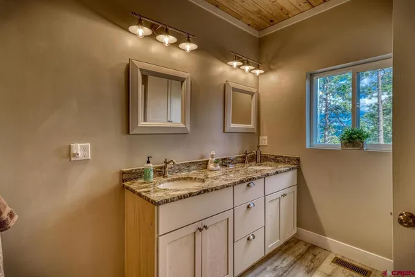 a bathroom with a granite countertop sink toilet and shower