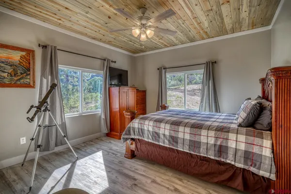 a bedroom with furniture and a flat screen tv