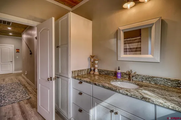 a bathroom with a granite countertop sink a window and a mirror