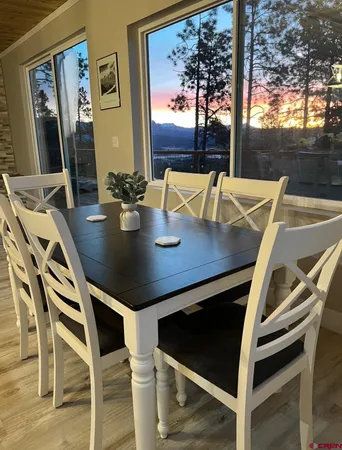 a view of a dining room with furniture and window