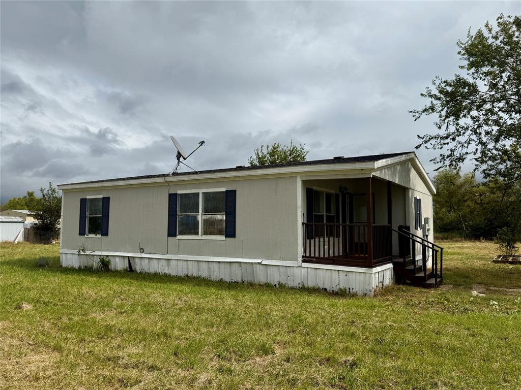 9123 Rodeo Drive Terrell, TX 75160 - Photo 12 of 16 a front view of a house with a garden