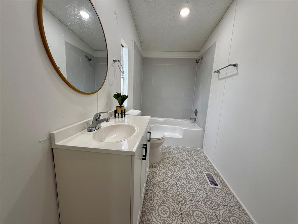 9123 Rodeo Drive Terrell, TX 75160 - Photo 8 of 16 a bathroom with a sink and a mirror