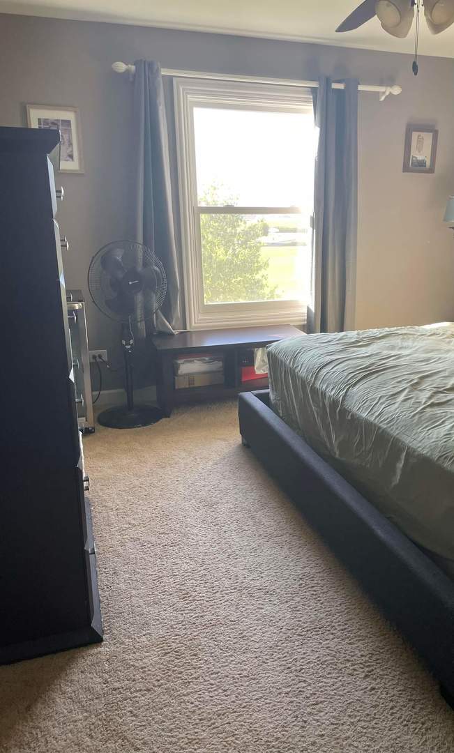 25113 Faraday Road Manhattan, IL 60442 - Photo 6 of 6 a bed sitting in a bedroom next to a window