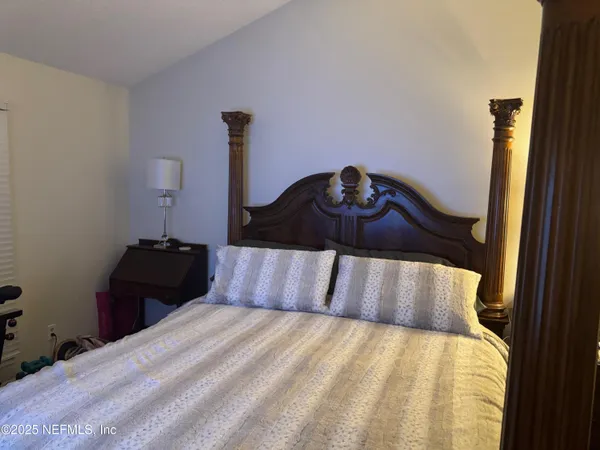 a bedroom with a bed and a table