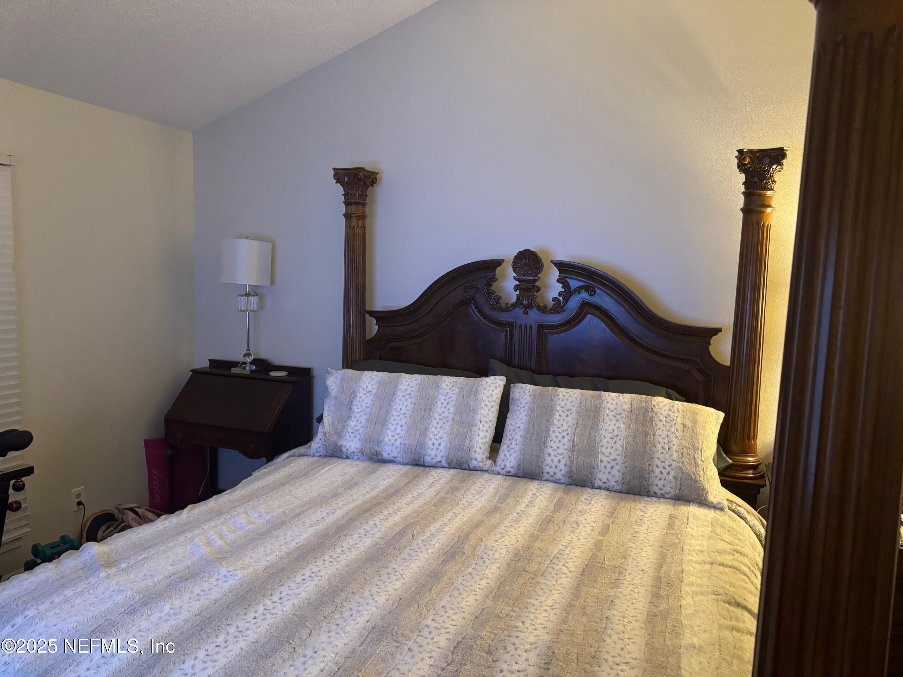 4734 Gulf Stream Court Fernandina Beach, FL 32034 - Photo 4 of 8 a bedroom with a bed and a table