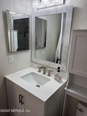a bathroom with a sink and a mirror
