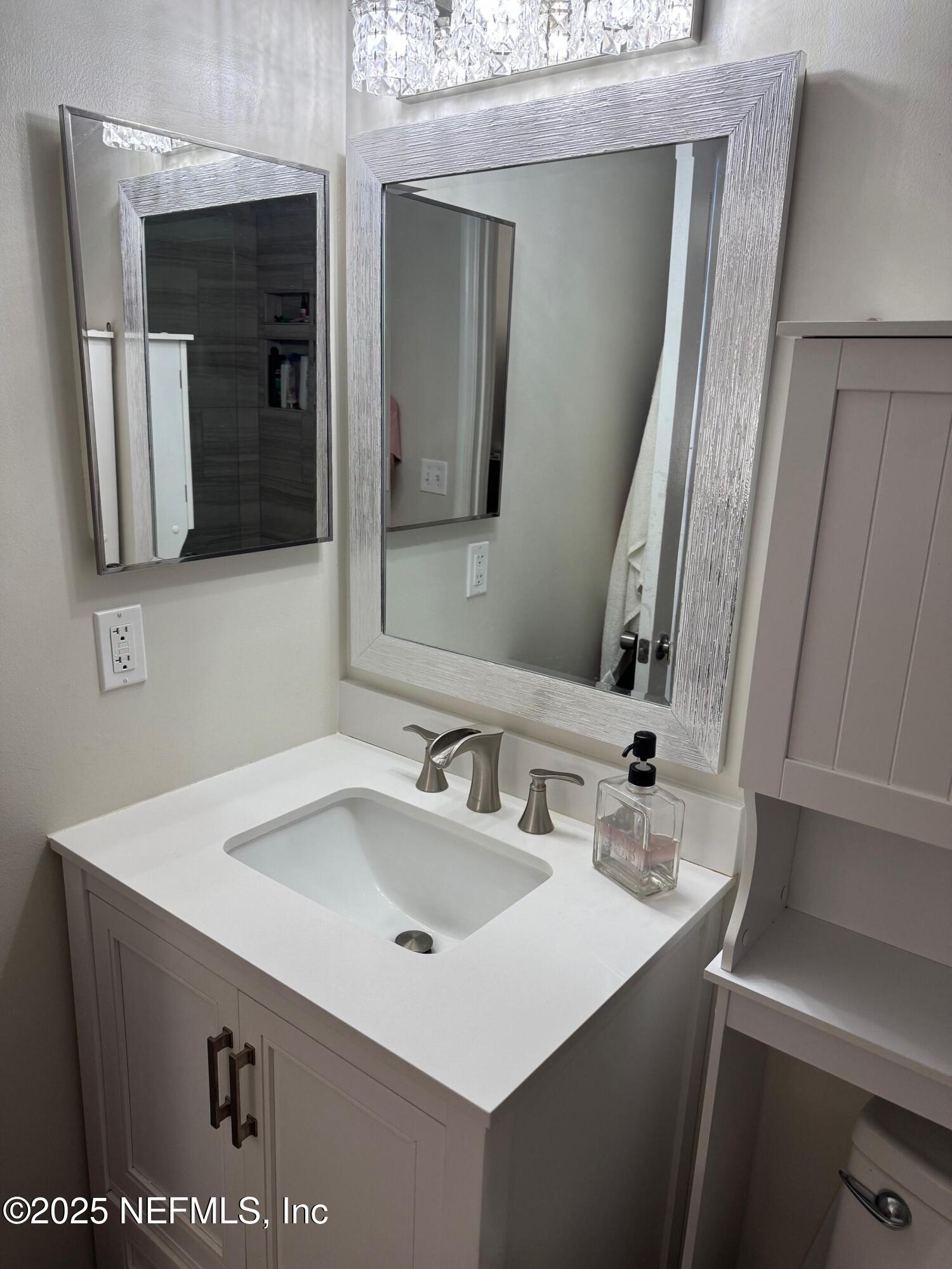 4734 Gulf Stream Court Fernandina Beach, FL 32034 - Photo 5 of 8 a bathroom with a sink and a mirror