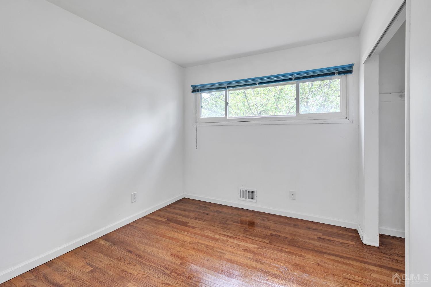 129 Princeton Road Old Bridge, NJ 08859 - Photo 16 of 26 wooden floor in an empty room with a window