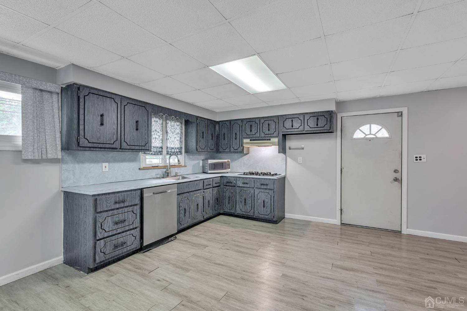 129 Princeton Road Old Bridge, NJ 08859 - Photo 7 of 26 a kitchen with cabinets wooden floor and stainless steel appliances