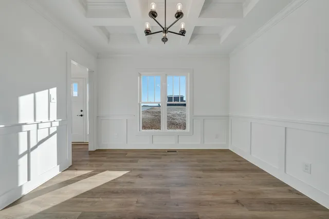 a kitchen with white cabinets and appliances
