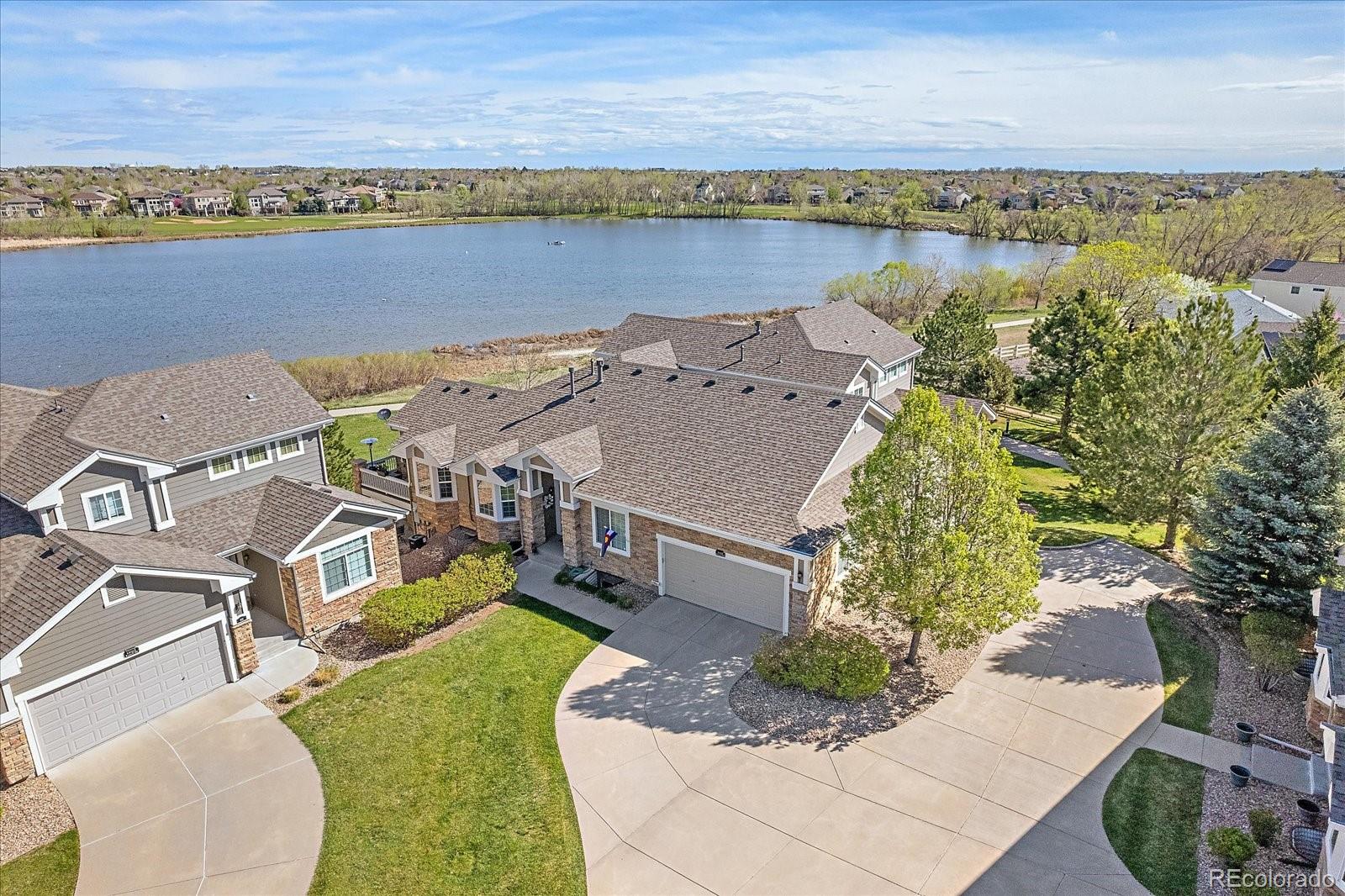 an aerial view of a house with a lake view