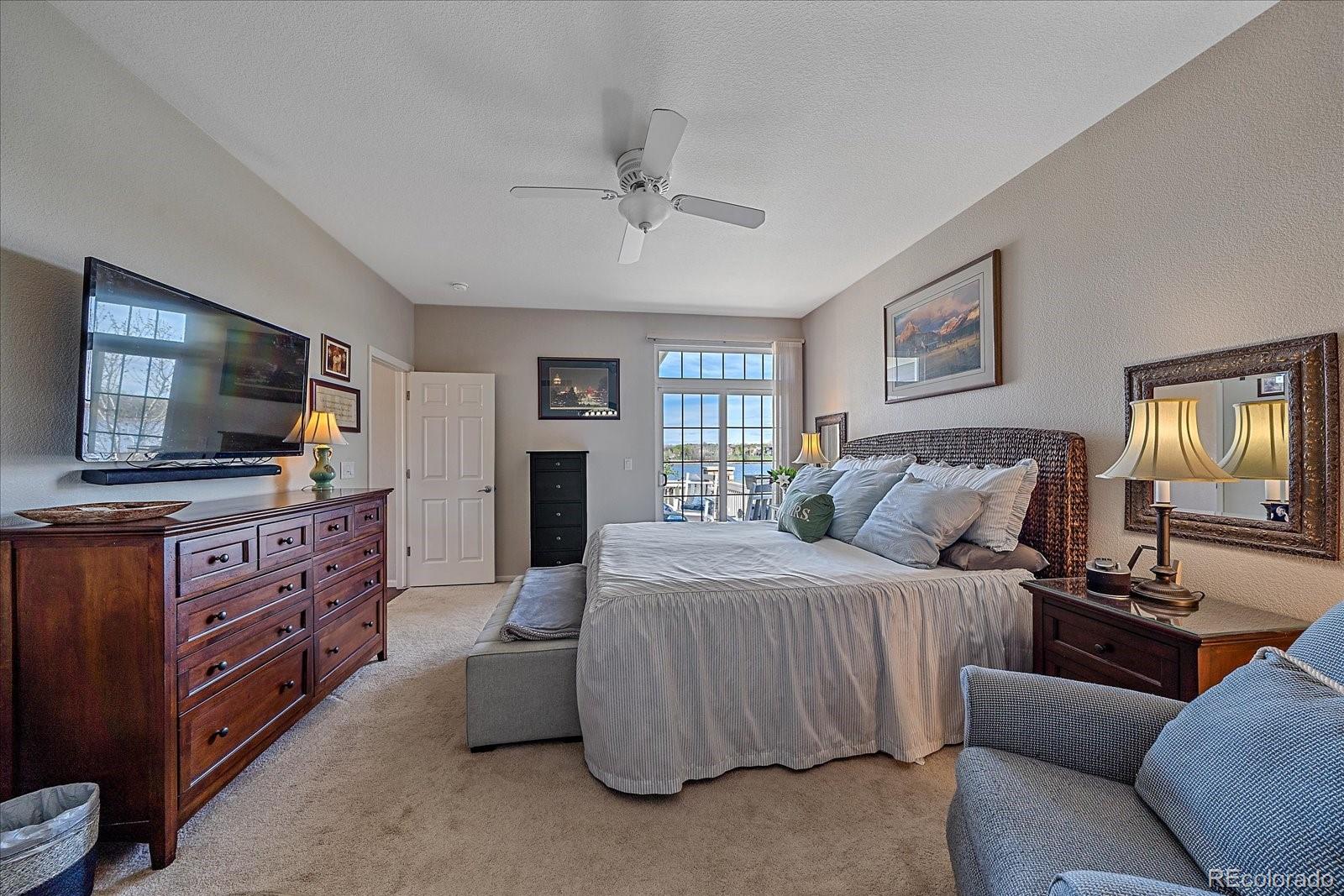 13721 Plaster Point, Unit 102 Broomfield, CO 80023 - Photo 12 of 35 a bedroom with furniture and a flat screen tv
