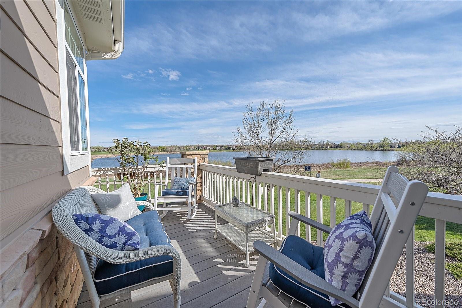 13721 Plaster Point, Unit 102 Broomfield, CO 80023 - Photo 15 of 35 a view of a balcony with chair and wooden floor