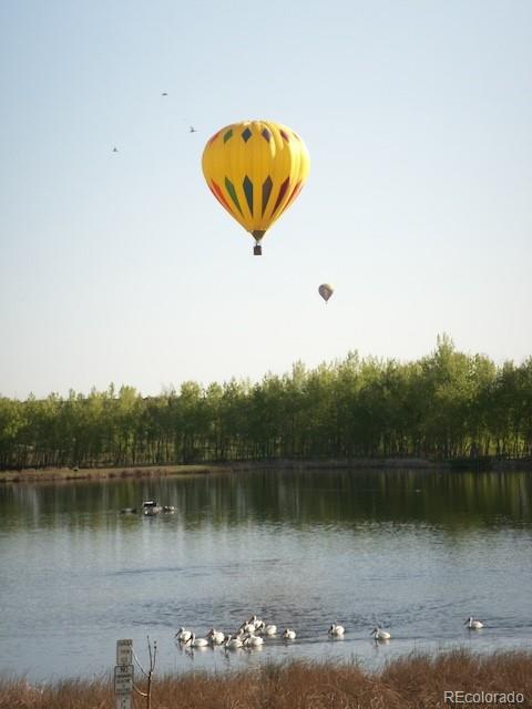 13721 Plaster Point, Unit 102 Broomfield, CO 80023 - Photo 16 of 35 a view of a lake with a bridge