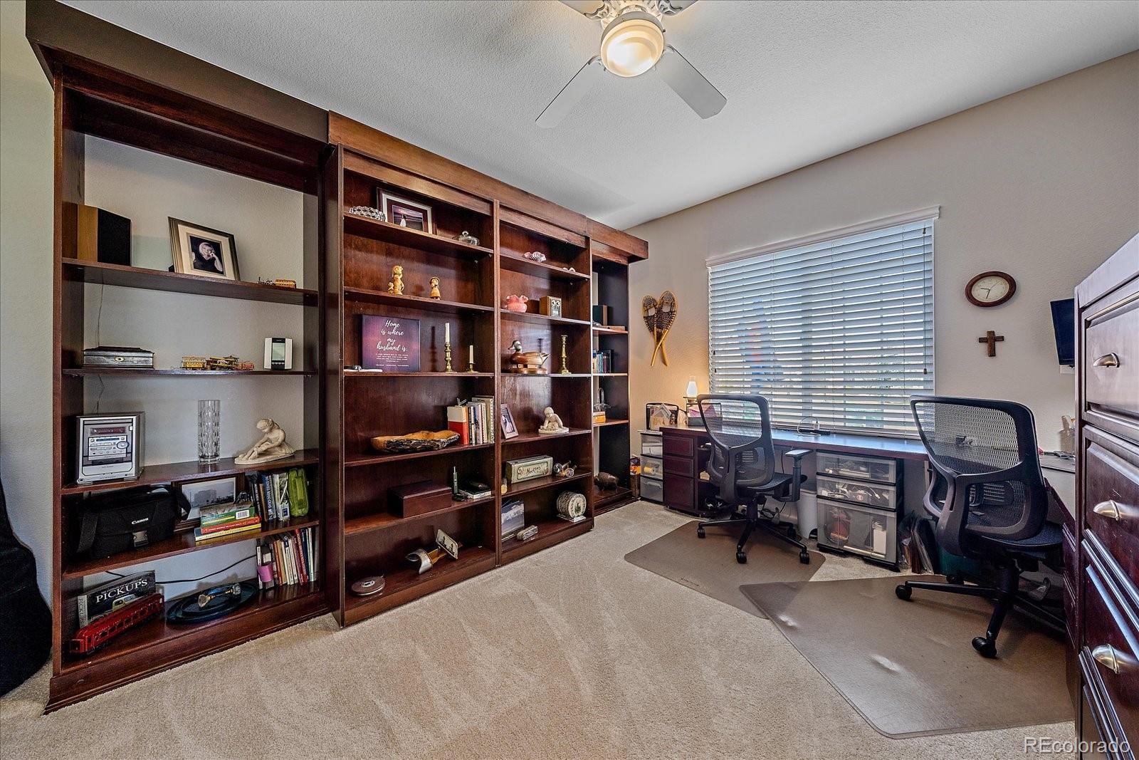 13721 Plaster Point, Unit 102 Broomfield, CO 80023 - Photo 19 of 35 a room with furniture and a book shelf