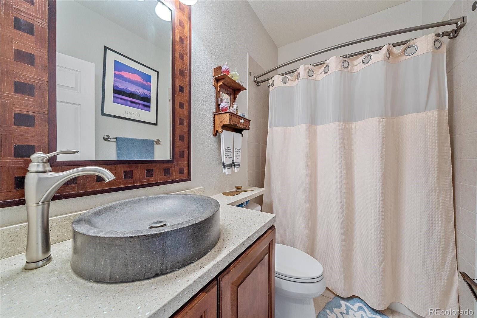 13721 Plaster Point, Unit 102 Broomfield, CO 80023 - Photo 21 of 35 a bathroom with a sink toilet and shower