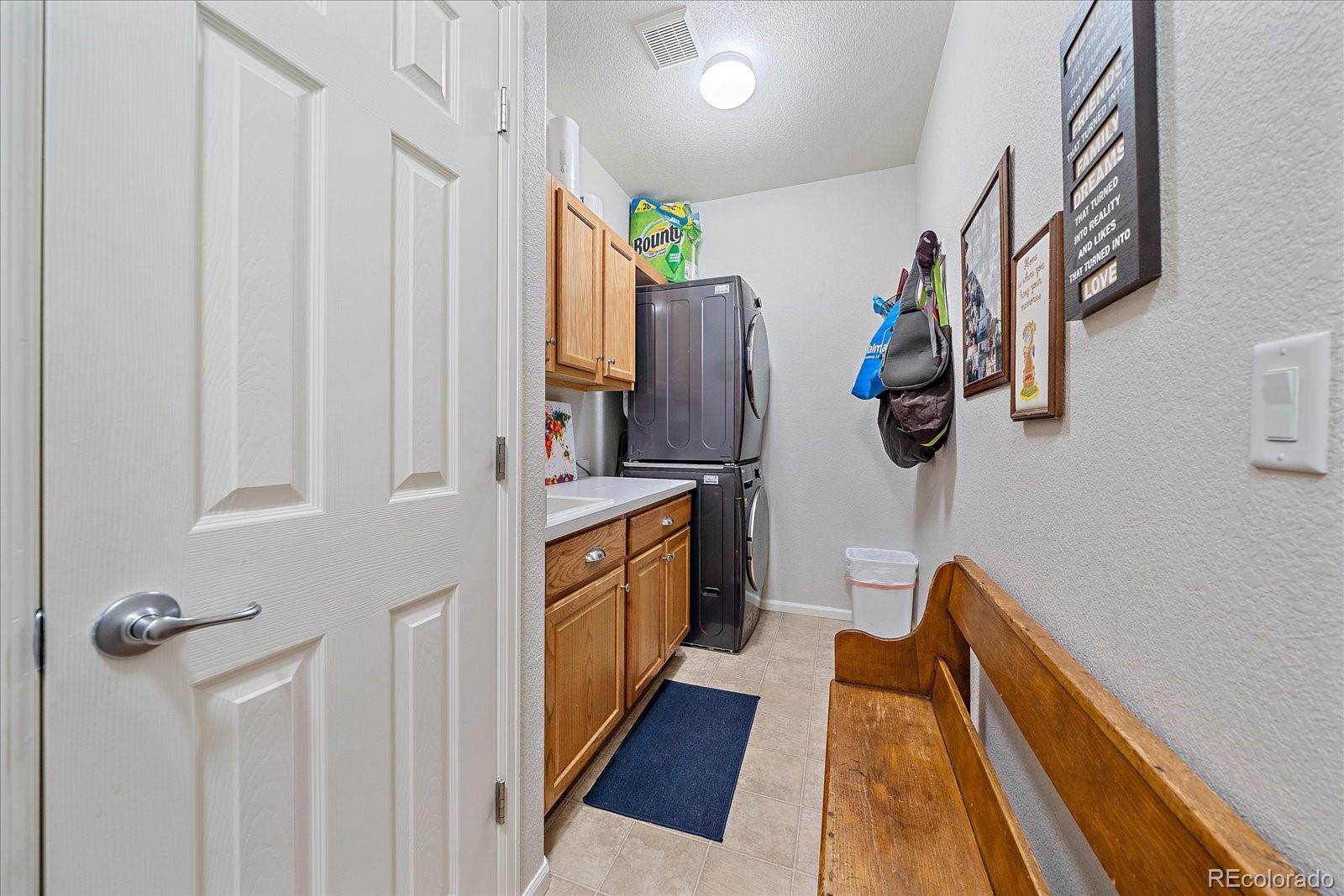 13721 Plaster Point, Unit 102 Broomfield, CO 80023 - Photo 22 of 35 a hallway with a white cabinets and wooden floor