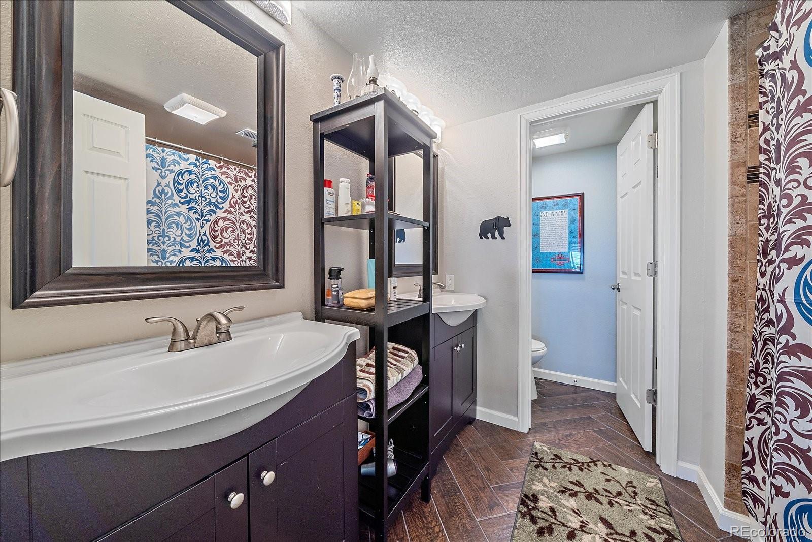 13721 Plaster Point, Unit 102 Broomfield, CO 80023 - Photo 27 of 35 a bathroom with a sink and a mirror
