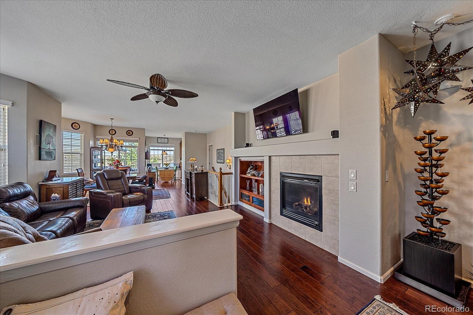 13721 Plaster Point, Unit 102 Broomfield, CO 80023 - Photo 3 of 35 a living room with furniture and a fireplace