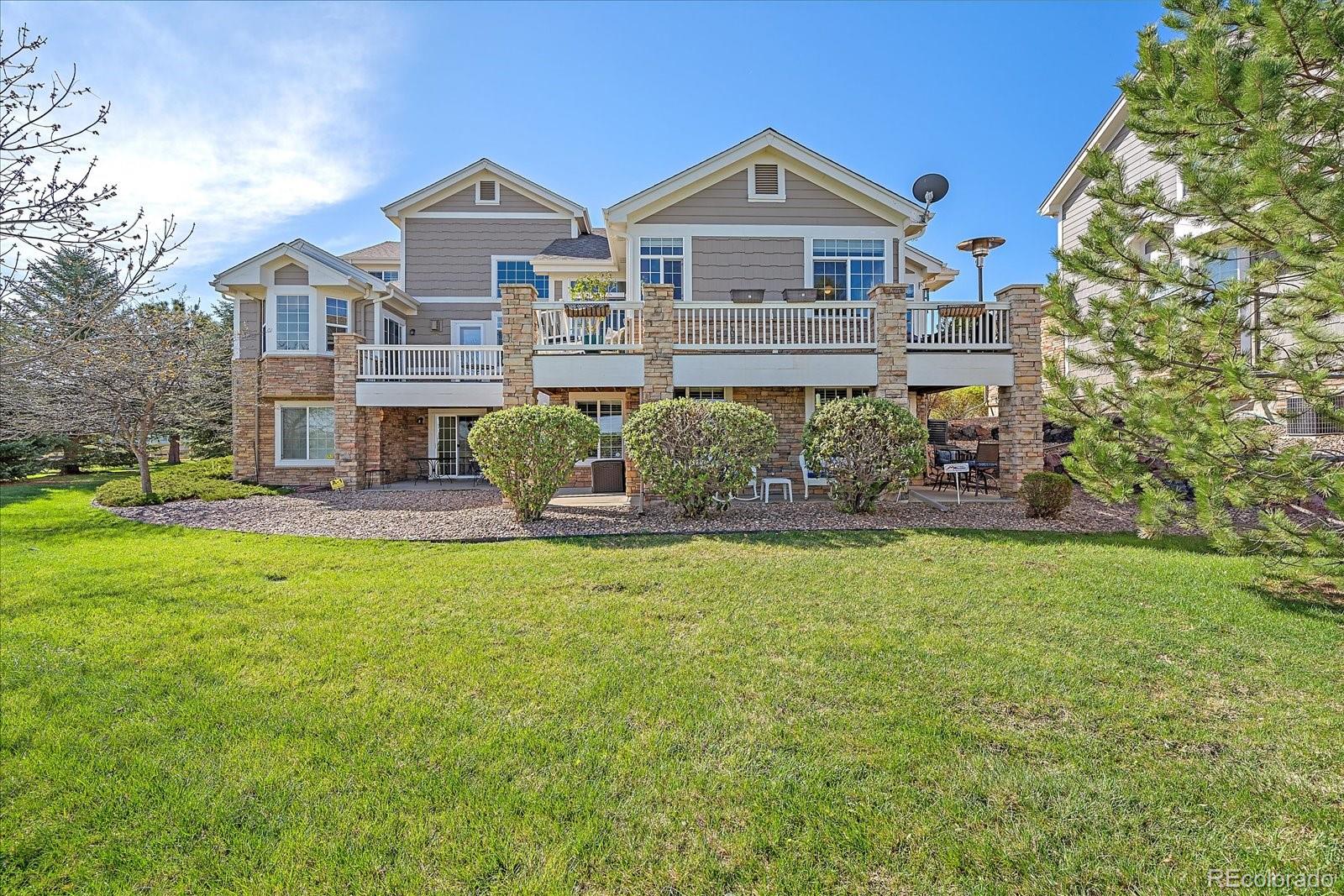 13721 Plaster Point, Unit 102 Broomfield, CO 80023 - Photo 31 of 35 a front view of a house with garden