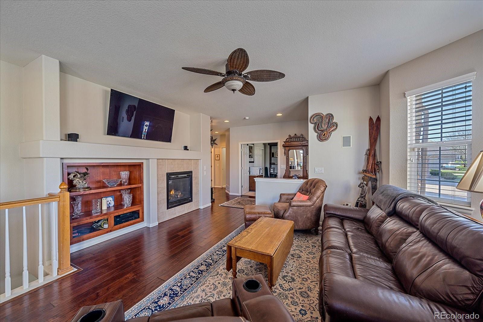 13721 Plaster Point, Unit 102 Broomfield, CO 80023 - Photo 5 of 35 a living room with furniture fireplace and flat screen tv