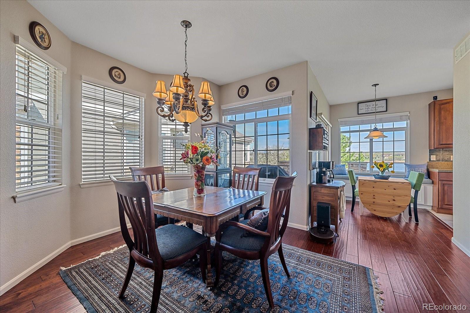 13721 Plaster Point, Unit 102 Broomfield, CO 80023 - Photo 6 of 35 a view of a dining room with furniture window and wooden floor