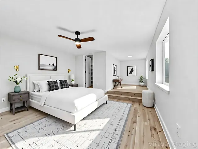 a bedroom with a large bed and a chandelier