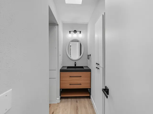 a room with a mirror and a wooden floor