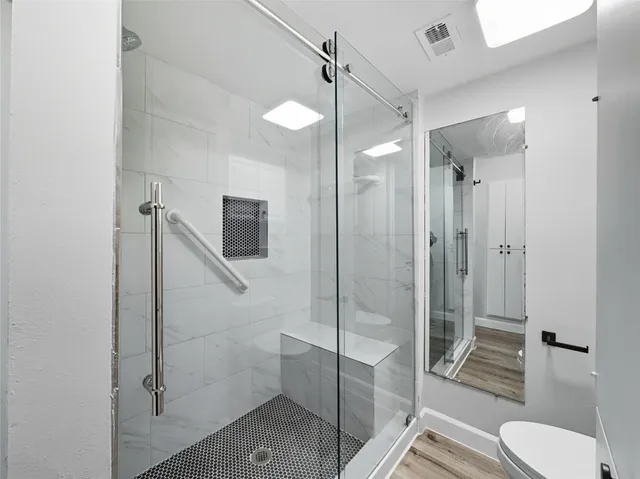 a bathroom with a shower and toilet